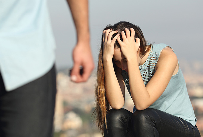 Women upset from family violence as man walks away