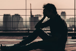 Man sitting with head in hands suffering depression