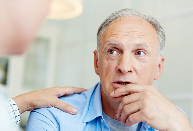 Man experiencing abuse in his relationship speaking with a health professional