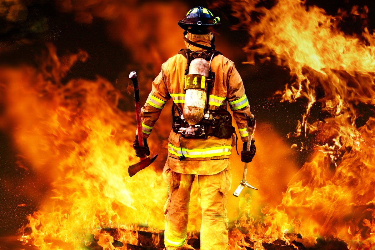 Firefighter facing flames