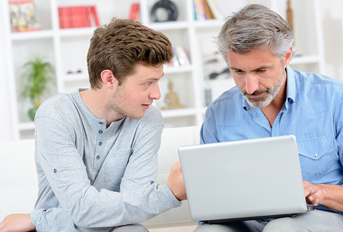 Father and son looking at a laptop