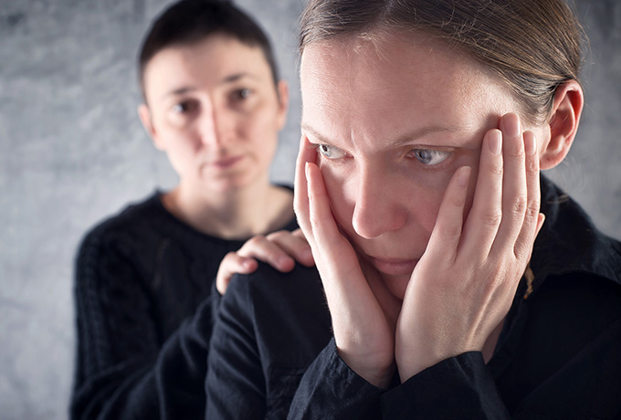 Women being comforted by her friend