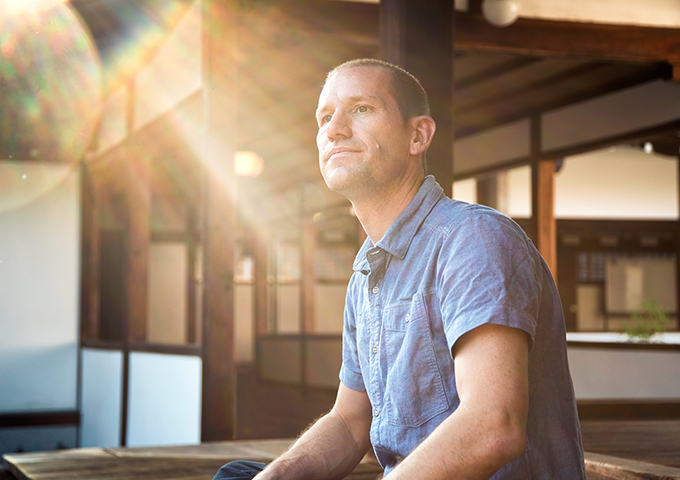 Man sitting and looking serious and hopeful