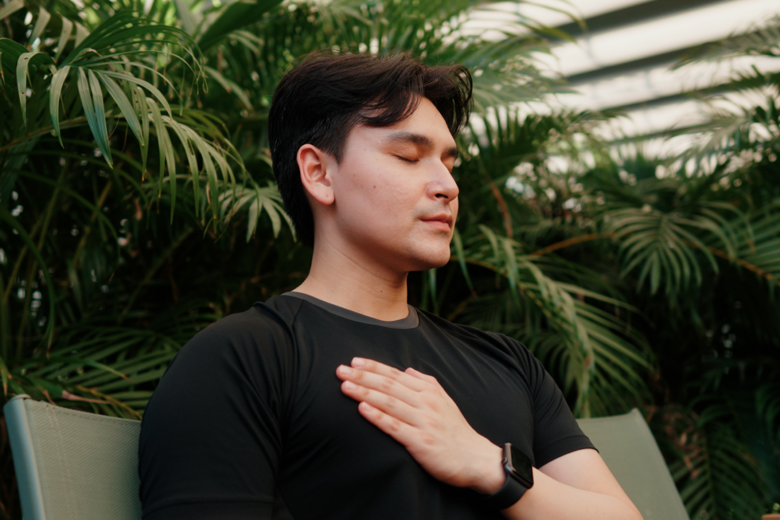 Man meditating with one hand on his chest