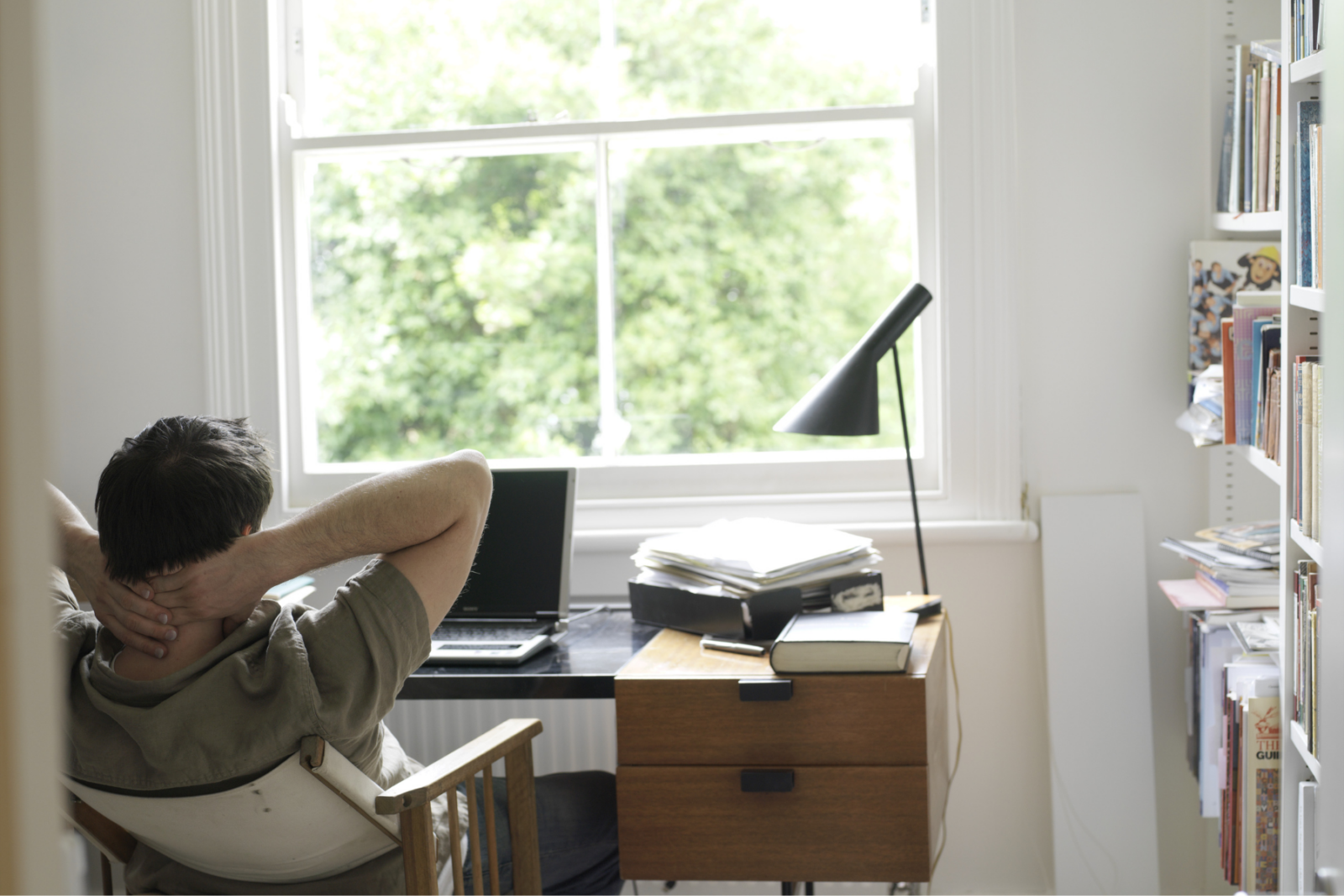 Man leaning back in chair in office