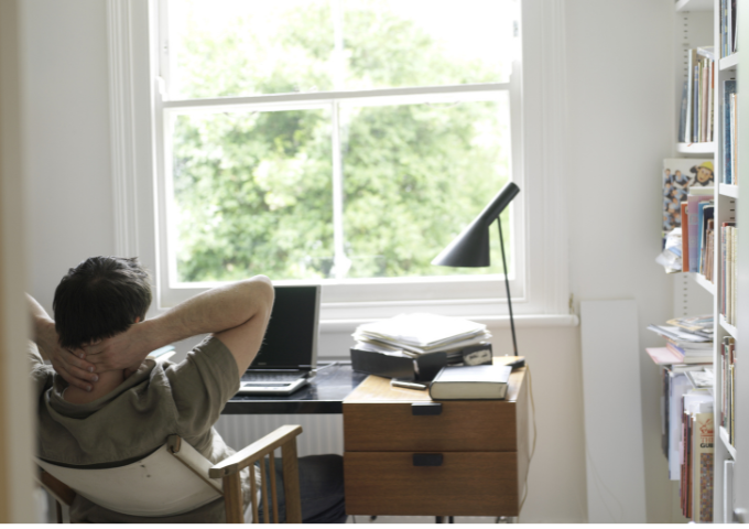 Man leaning back in chair in office
