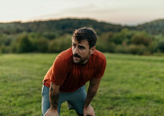 Man taking a rest whilst exercising outdoors