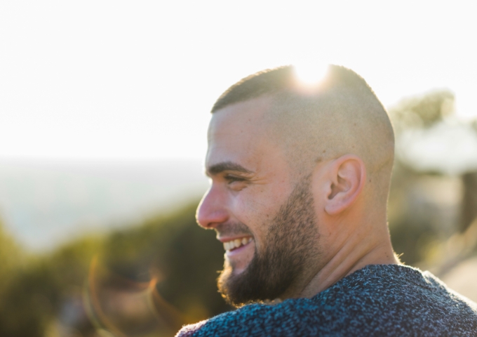 Close up portrait of man outside smiling and looking happy