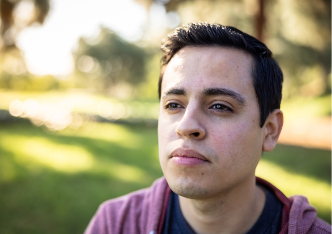 Close up portrait of male standing outside thinking