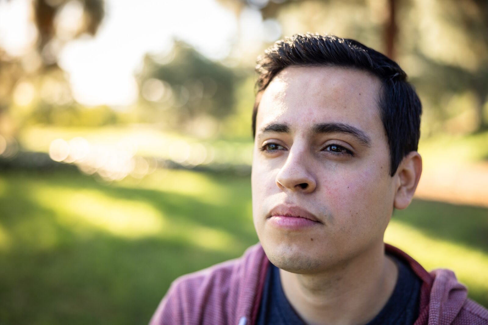 Close up portrait of male standing outside thinking
